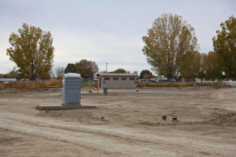 Porta potty and bathroom outside Clifton Community Campus. 