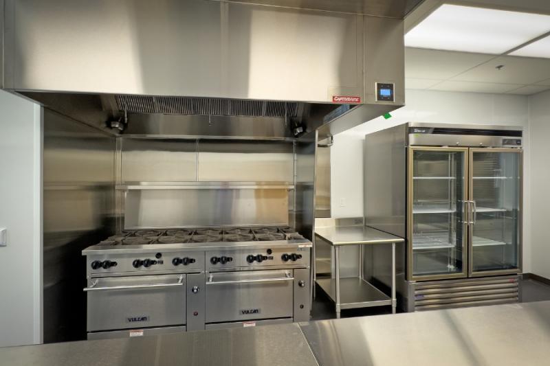 Commercial kitchen with silver appliances. 