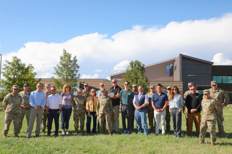 Large group photo of civilians and army soldiers. 