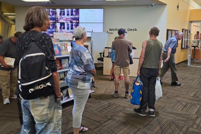 Several people standing in waiting room. 