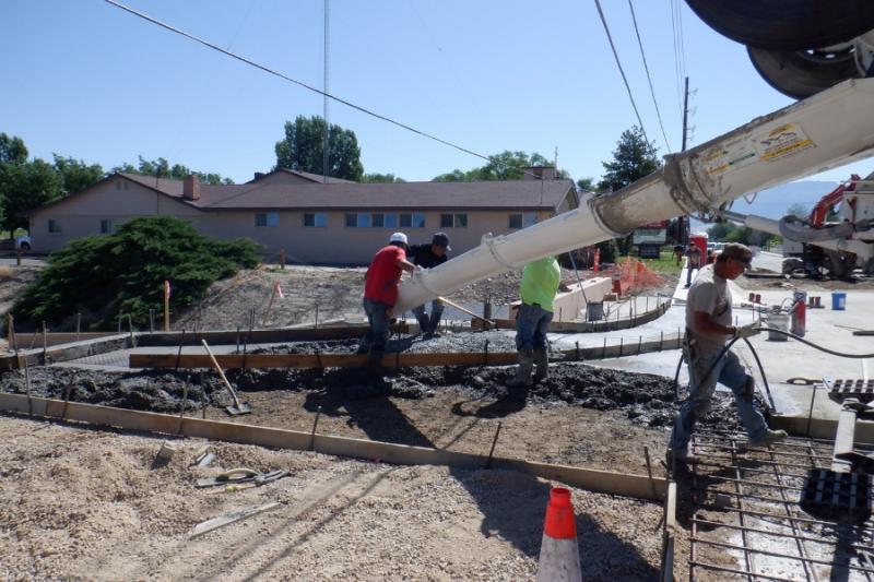 Three construction workers on construction site. 