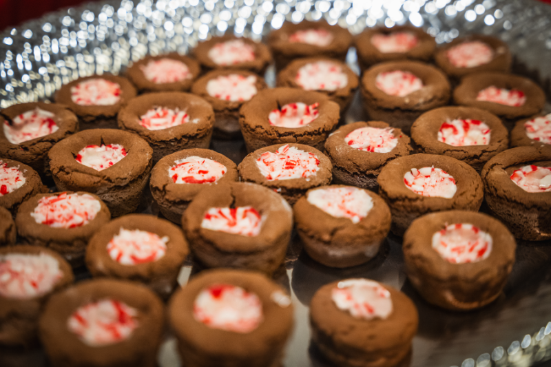 Brown cookies with red and white peppermints in the middle. 