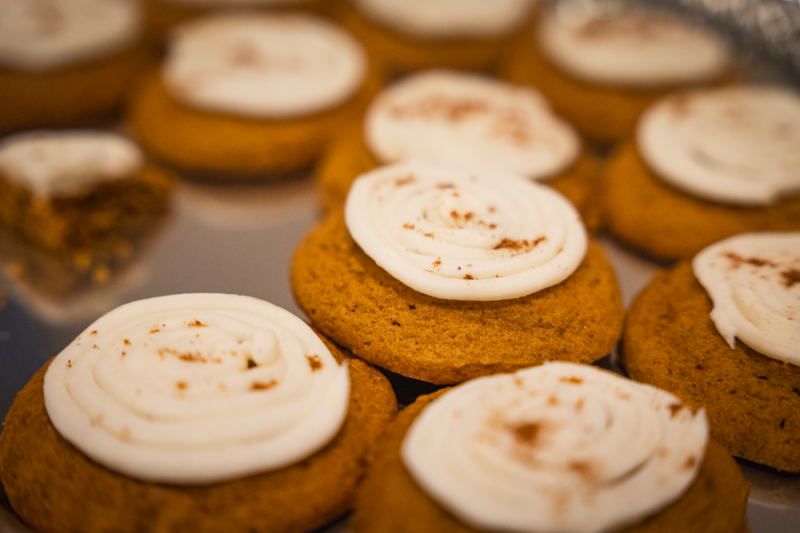 Pumpkin cookies with white frosting.