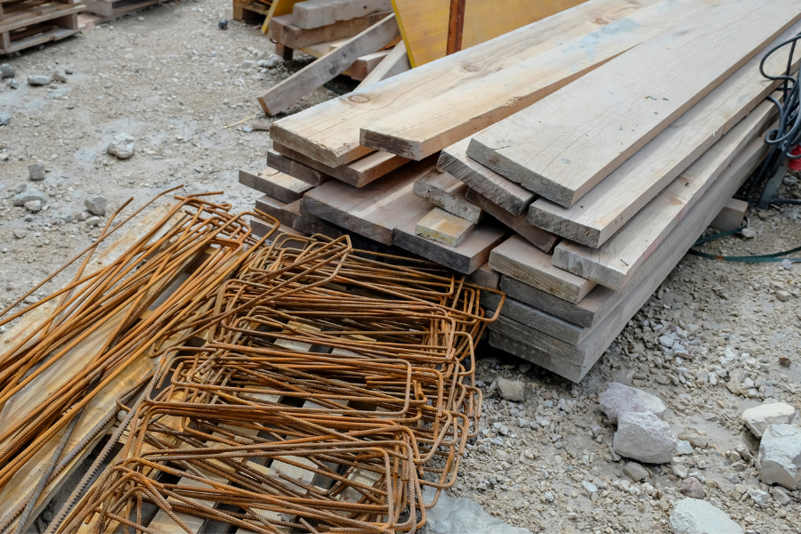 Pile of light brown wood and construction materials.