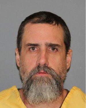 Inmate Robert Brannon dressed in a yellow jumpsuit. 
