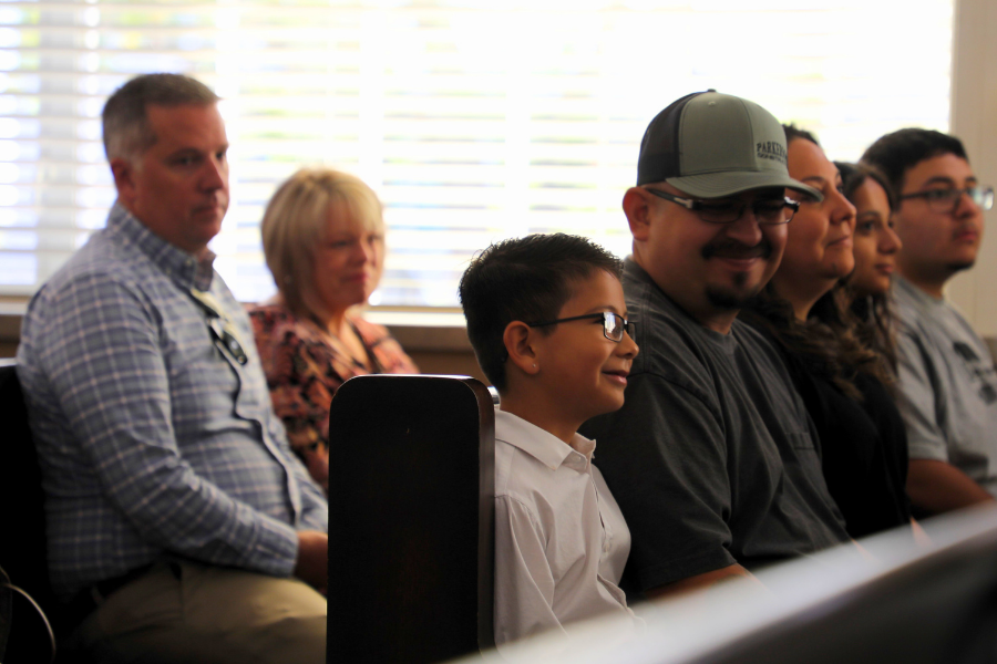 Joaquin Moncada and family sitting in Mesa County Public Hearing Room. 