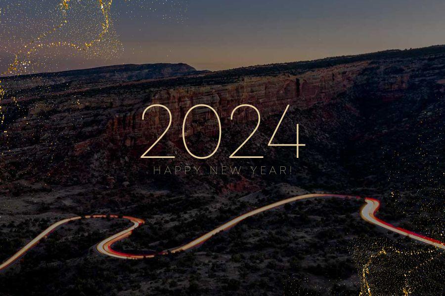 Dark image of Mesa County with gold text reading "2024 Happy New Year!"