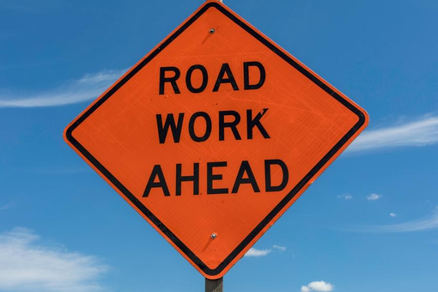 Orange sign reading, "road work ahead."